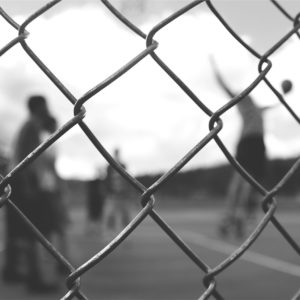 Feeling Depressed After Sports Retirement | Photo of a fence in front of a basketball court