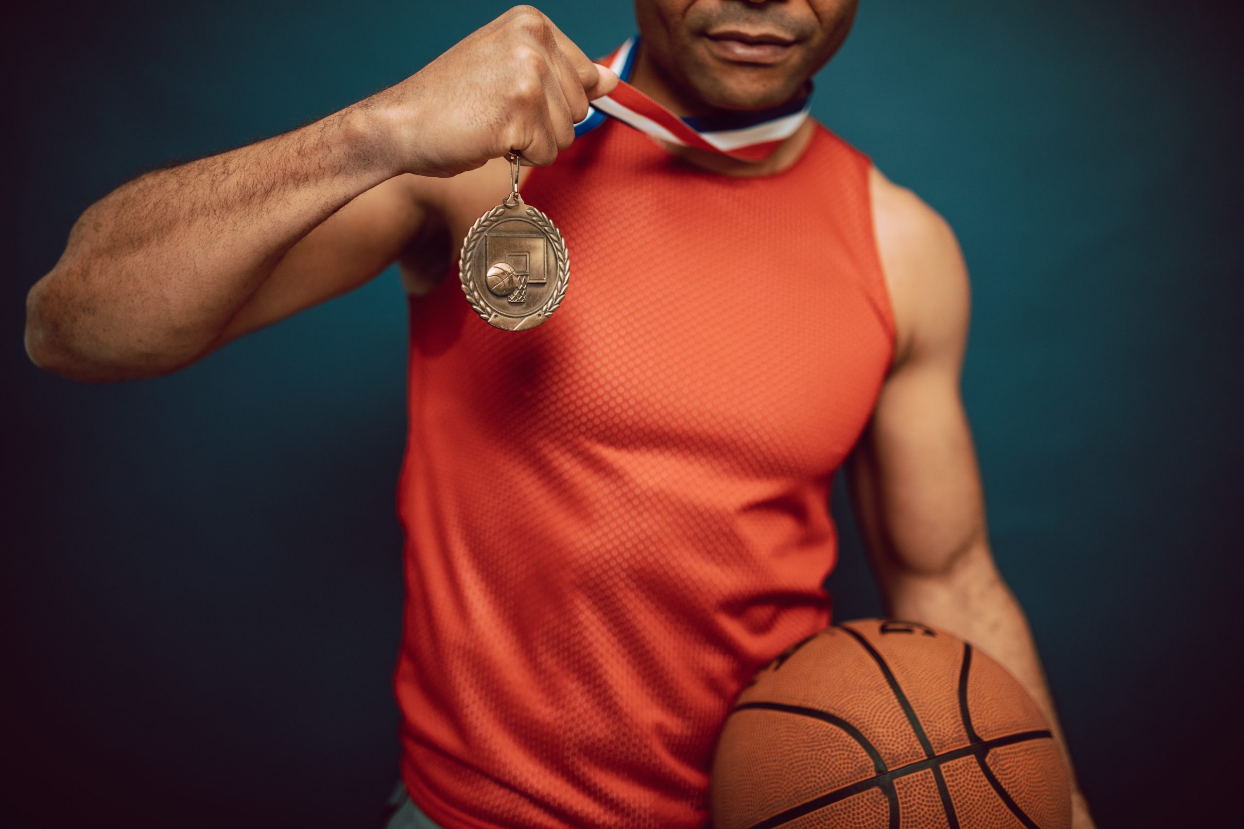 5 Ways Athletes Can Boost Their Self-Confidence | Athlete Basketball Player Holding a Gold Medal
