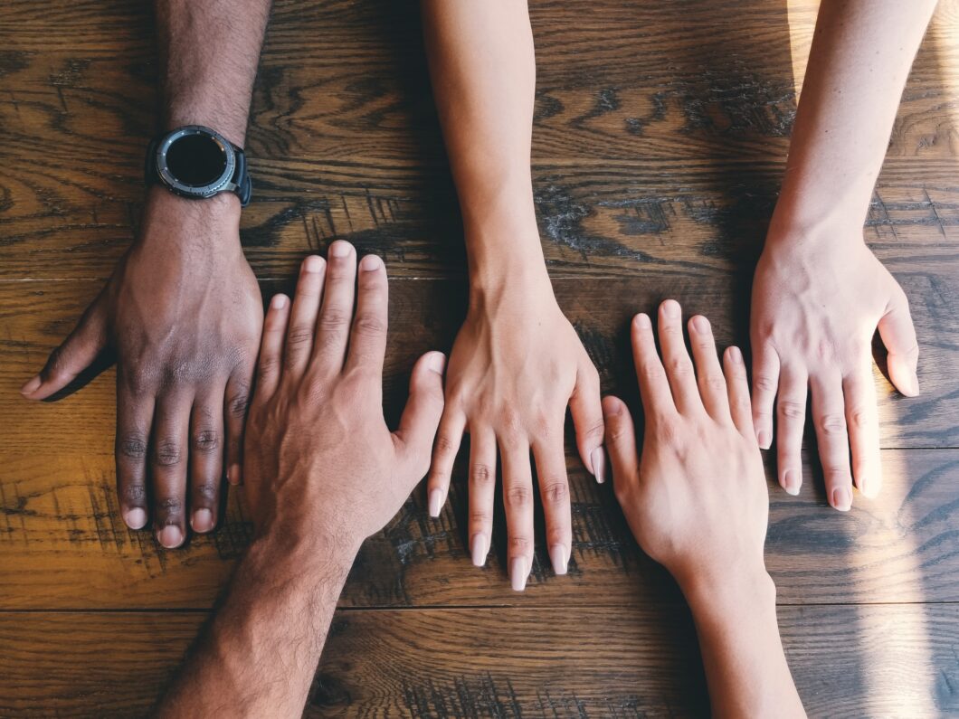 Athlete Peer Groups article - image shows hands together - Photo by Clay Banks on Unsplash