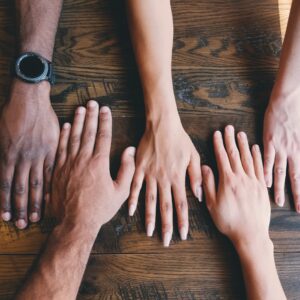 Athlete Peer Groups article - image shows hands together - Photo by Clay Banks on Unsplash