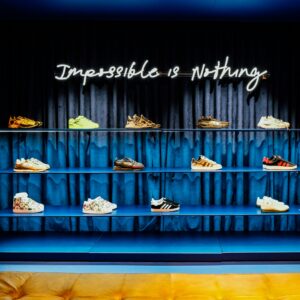 embrace challenges as opportunities; photo of sneakers with the words impossible is nothing