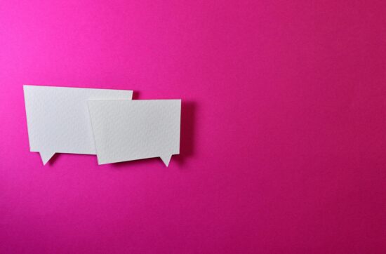 How to have difficult conversations - photo of two chat conversation balloons on pink background