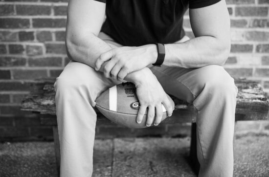 Spotlight on Male Athlete Mental Health During National Men's Health Awareness Month | Male holding a football