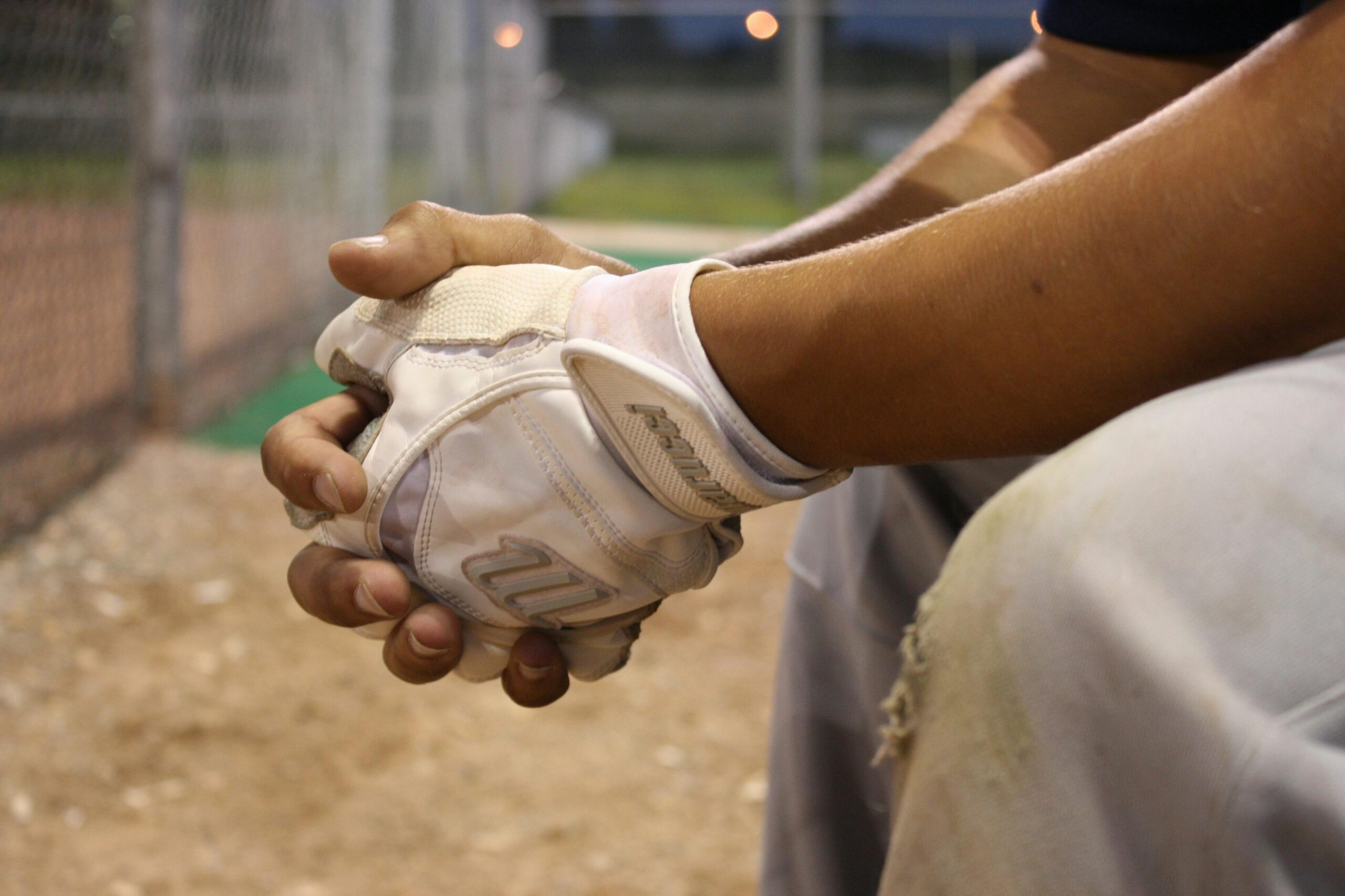 How to Overcome Mental Blocks in Sports: Mindset Tools for Athletes Featured image showing a closeup of a baseball player hands and sitting on a bench