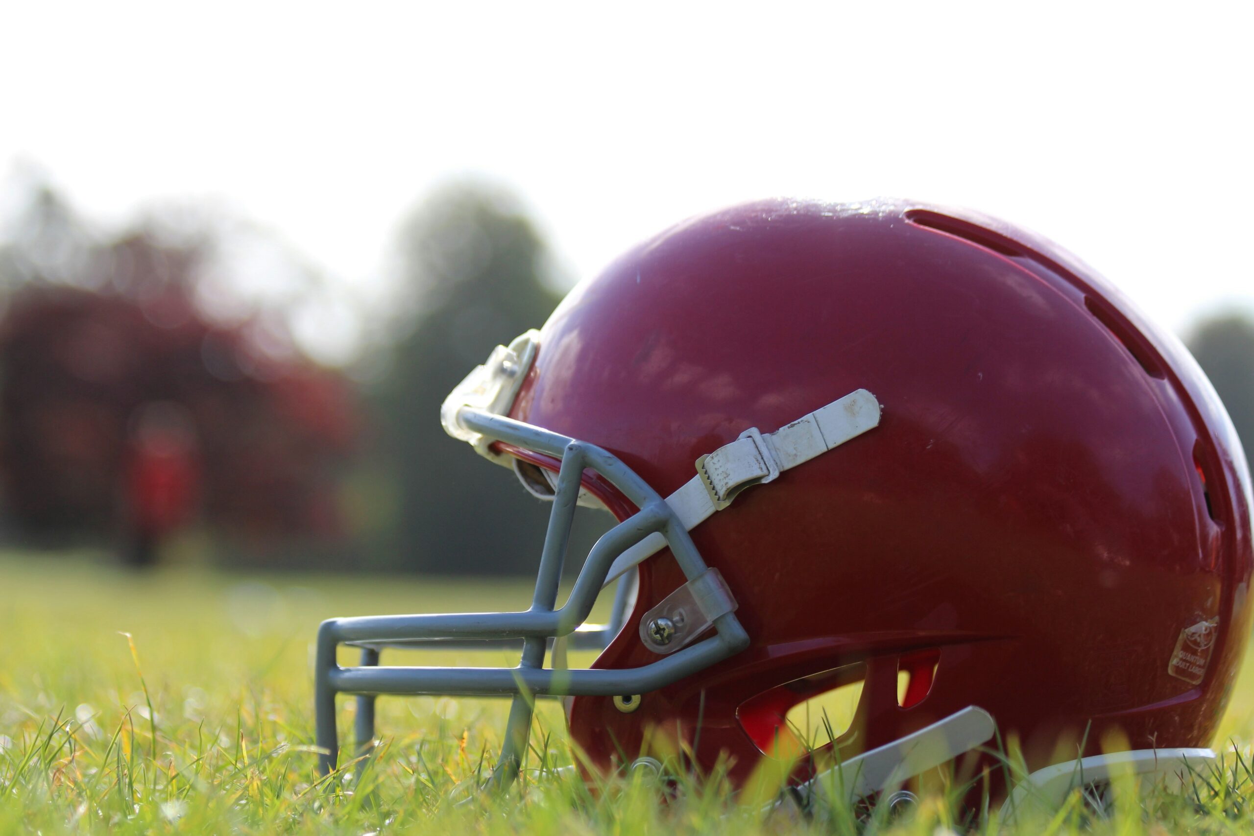 How to Integrate Athlete Mental Health Training Programs - photo of a red football helmet on a field